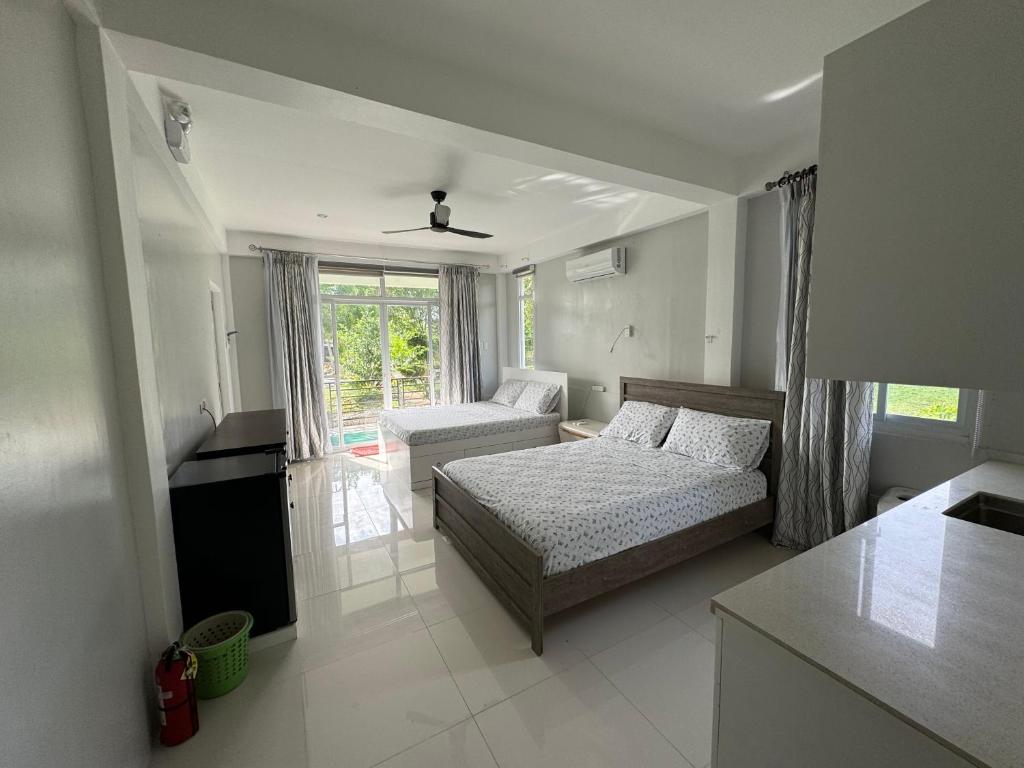 INATO SUITES Rm 1 1 queen bed and a pullout sofa bed